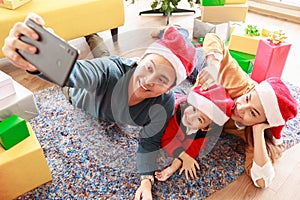 Asian Selfie holding smartphone Taking picture. Happy young family with kids fun celebrating Christmas. Christmas time. My dad,