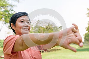 Asian Senior Chinese woman stretching hands