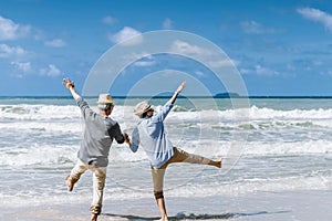 Asian senior couple or elderly people walking and siting at the beach