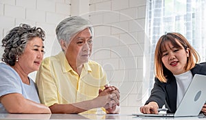 Asian senior couple with financial advisor about tax and retirement document at home.happy aging at home concept