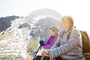 Asian senior couple hiking on the mountain