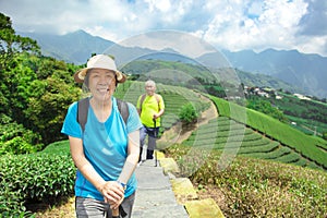 asian senior couple hiking in the nature