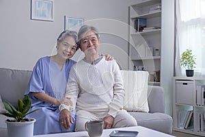 Asian Senior couple at home. Handsome old man and attractive old woman are spending time together.