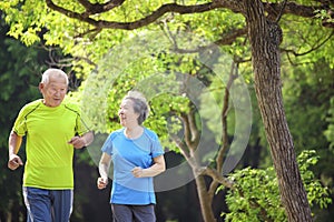 Asian Senior Couple  jogging in the nature park