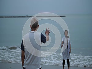 Asian senior couple relax playing at morning sea happy lifestyle retirement