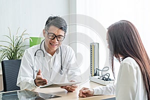 Asian senior doctor and patient are discussing