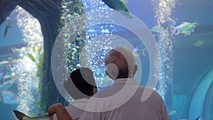 Asian senior elder couple dating in Aquarium new normal condition with mask fun happy relax trip together