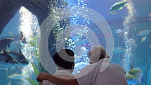 Asian senior elder couple dating in Aquarium new normal condition with mask fun happy trip together