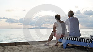 Asian senior elder couple relax enjoy have fun on tropical seaside morning vacation retirement trip