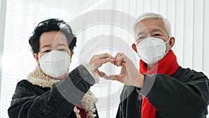 Asian senior elder couple send encourage for Covid-19 pandemic wearing mask