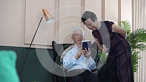 Asian senior elder couple sharing information on tablet together enjoy life at home