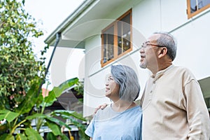 Asian Senior elderly couple standing outdoor at house feeling happy and enjoy retirement life together. Loving Older grandparent s