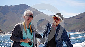 Asian senior elderly couple on tourist ferry boat to seals island trip attracion Fun wildlife watching aticity in South Africa