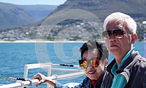 Asian senior elderly couple on tourist ferry boat to seals island trip attracion Fun wildlife watching aticity in South Africa
