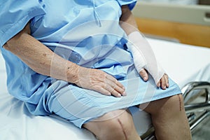 Asian senior or elderly old lady woman patient accident at arm with bandage on bed in nursing hospital