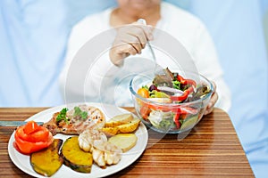 Asian senior or elderly old lady woman patient eating breakfast