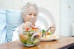 Asian senior or elderly old lady woman patient eating breakfast