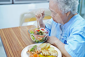 Asian senior or elderly old lady woman patient eating breakfast