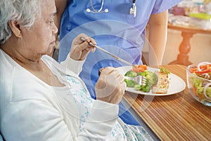 Asian senior or elderly old lady woman patient eating breakfast healthy food with hope