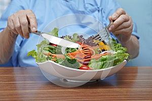 Asian senior or elderly old lady woman patient eating salad vegetable breakfast healthy food