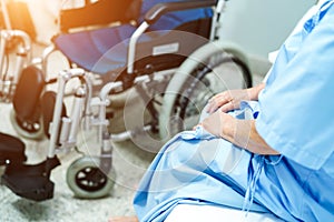 Asian senior or elderly old lady woman patient sitting on bed with wheelchair in nursing hospital ward : healthy strong medical co