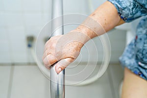 Asian senior or elderly old lady woman patient use bathroom handle security