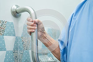 Asian senior or elderly old lady woman patient use slope walkway handle security with help support assistant in nursing hospital
