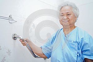 Asian senior or elderly old lady woman patient use toilet bathroom handle security