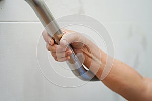 Asian senior or elderly old lady woman patient use toilet bathroom handle security in nursing hospital