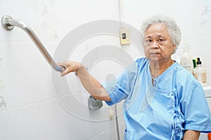 Asian senior or elderly old lady woman patient use toilet bathroom handle security in nursing hospital