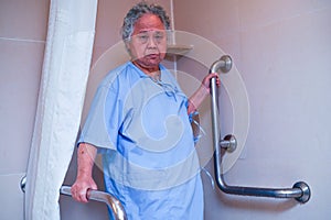 Asian senior or elderly old lady woman patient use toilet bathroom handle security in nursing hospital ward