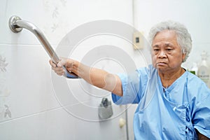 Asian senior or elderly old lady woman patient use toilet bathroom handle security in nursing hospital ward