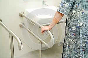 Asian senior or elderly old lady woman patient use toilet bathroom handle security in nursing hospital ward