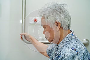 Asian senior or elderly old lady woman patient use toilet bathroom handle security in nursing hospital ward