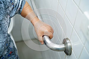 Asian senior or elderly old lady woman patient use toilet bathroom handle security in nursing hospital ward