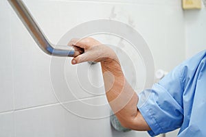 Asian senior or elderly old lady woman patient use toilet bathroom handle security in nursing hospital ward