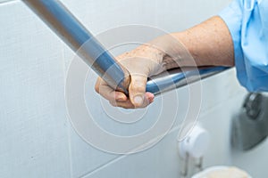 Asian senior or elderly old lady woman patient use toilet bathroom handle security in nursing hospital ward