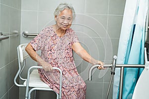 Asian senior or elderly old lady woman patient use toilet bathroom handle security in nursing hospital ward, healthy strong