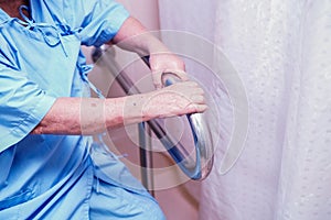 Asian senior or elderly old lady woman patient use toilet bathroom handle security in nursing hospital ward