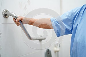 Asian senior or elderly old lady woman patient use toilet bathroom handle security in nursing hospital ward