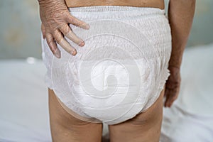 Asian senior or elderly old lady woman patient wearing incontinence diaper in nursing hospital ward, healthy strong medical