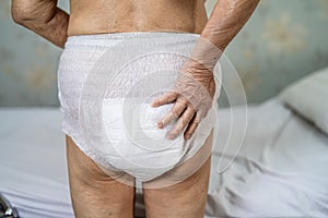 Asian senior or elderly old lady woman patient wearing incontinence diaper in nursing hospital ward, healthy strong medical