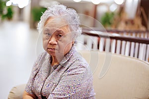 Asian senior or elderly old lady woman sitting and waiting her relative