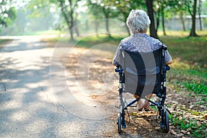 Asian senior or elderly old lady woman smile bright face patient on wheelchair in park.