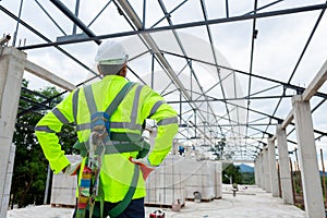 Asian senior engineer technician construction wearing safety harness and safety line working in construction site