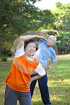 asian senior fitness couple in the park