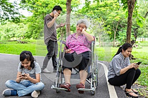Asian senior grandmother is being ignore from family,elderly  bored,sad,frustrated,disregard,parents,child girl with internet, photo
