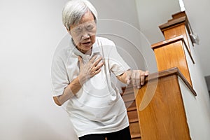 Asian senior grandmother suffering from pain in chest with acute dyspnea or asthma disease,Tired old elderly eyes closed and hand photo