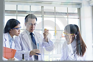 Asian senior laboratory scientist man working at lab with asian young student scientist backgroud