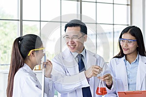 Asian senior laboratory scientist man working at lab with asian young student scientist backgroud